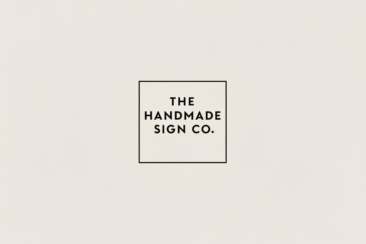 Logo of The Handmade Sign Co on a light gray background